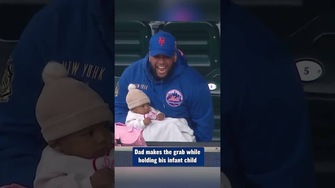 Baby in hand, no problem for Dad! He makes the one-handed grab while holding his infant child 👶