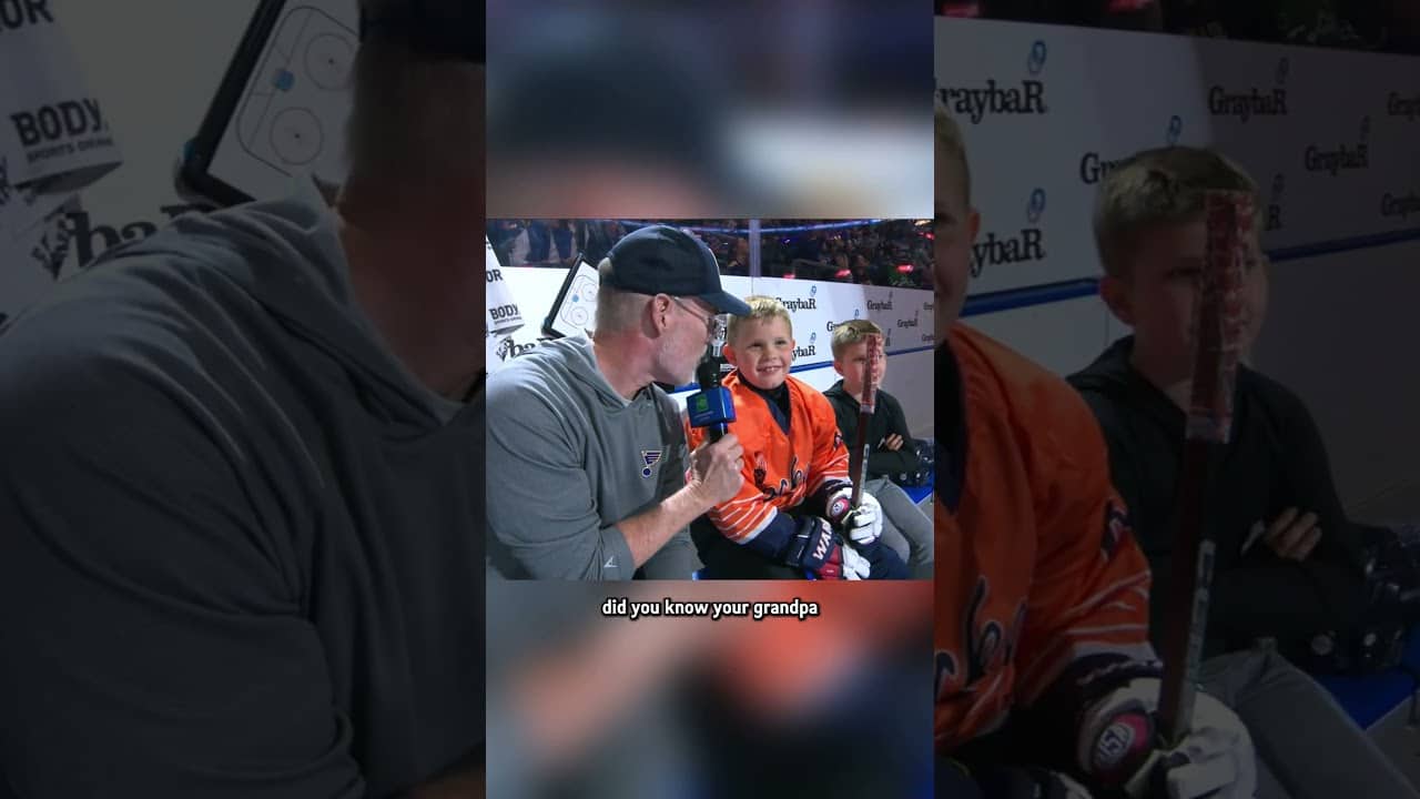 Joe Buck interviews sons during intermission at a Blues game