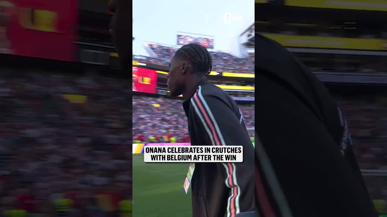 Belgium's Amadou Onana celebrates with his team after suffering from an injury earlier in the match